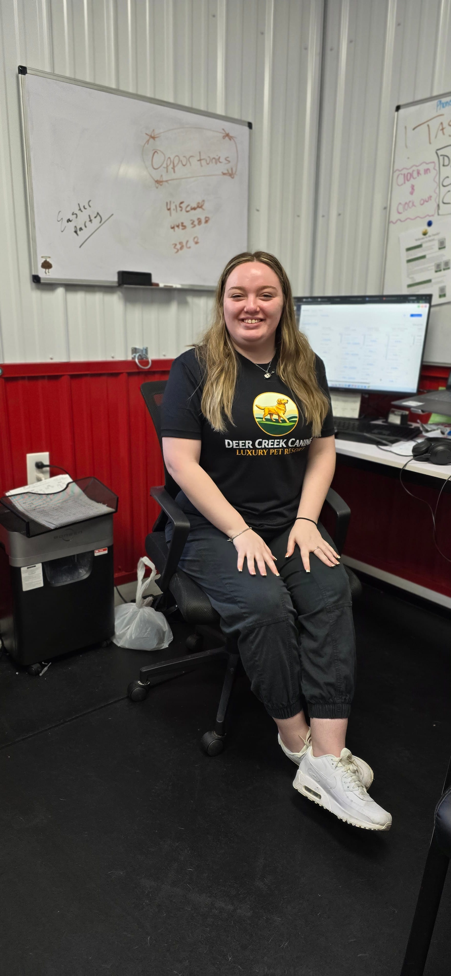 A staff member in a Deer Creek brand shirt outside on the resort grounds